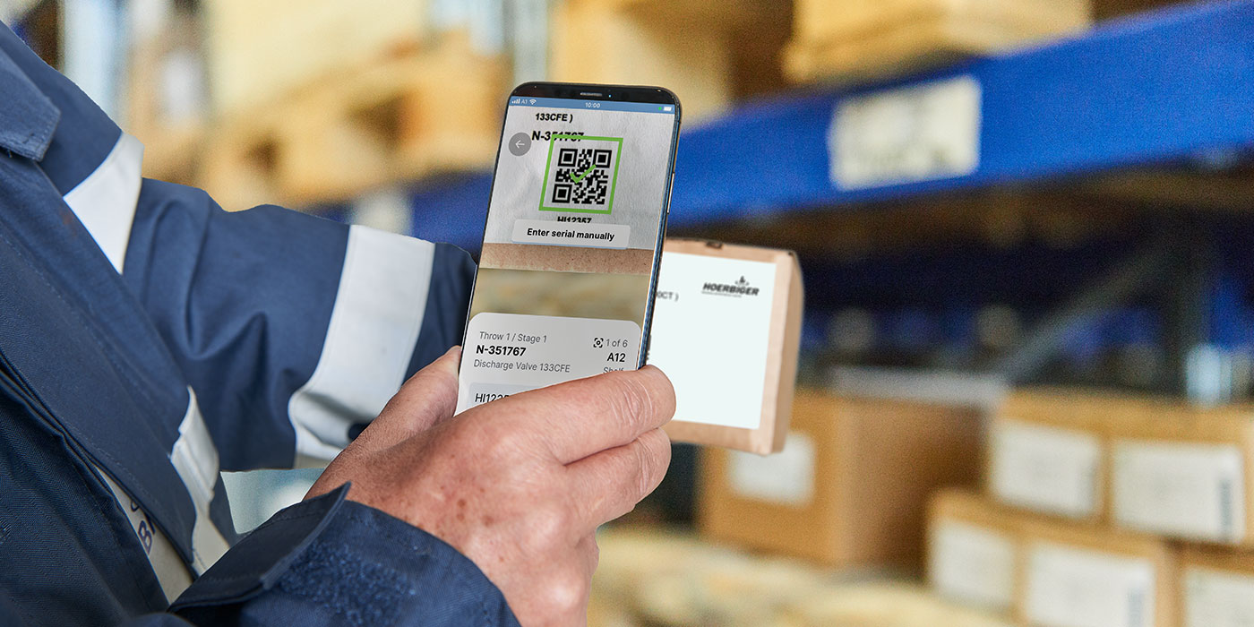 VISTRA®Repair scanning with App Man holding smartphone in his hand using the VISTRA App to scan a product
